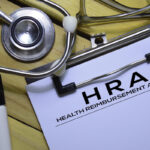 Health Reimbursement Account (HRA) text on Document form isolated on office desk. Health Reimbursement Account (HRA) text on Document form isolated on office desk.