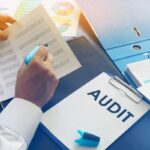Document with title Audit on an office table. Document with title Audit on an office table.
