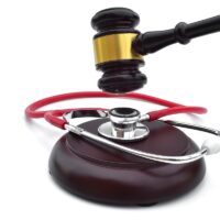 GAVEL WITH A STETHOSCOPE ON THE BASE 2