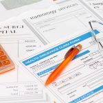 Surgery bills with health insurance claim calculator and pen