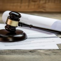 Gavel resting on medical documents symbolizing health-related legal dispute, healthcare law and justice system concept, medical malpractice or insurance claim case. Gavel resting on medical documents symbolizing health-related legal dispute, healthcare law and justice system concept, medical malpractice or insurance claim case.