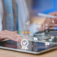 A person typing on a laptop with a stylus, surrounded by digital holograms of checkmarks, stars, and documents, conveying a tech-savvy, focused atmosphere.