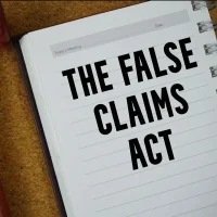 the-false-claims-act-text-written-on-notebook-paper-with-judges-gavel