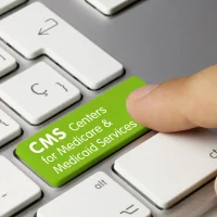 a-finger-presses-a-green-key-on-a-keyboard-labeled-cms-centers-for-medicare-medicaid-services a-finger-presses-a-green-key-on-a-keyboard-labeled-cms-centers-for-medicare-medicaid-services