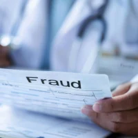 doctor-reviewing-fraud-document-in-medical-office-with-stethoscope-in-background
